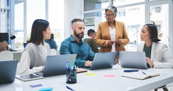 Business people, laptop and meeting, marketing team at digital agency, creative group and research