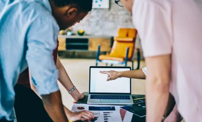 Business person team working with blank screen laptop at office