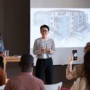 Businesswoman holding presentation for business people