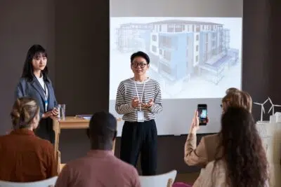 Businesswoman holding presentation for business people
