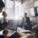 Businesswoman working on laptop in meeting