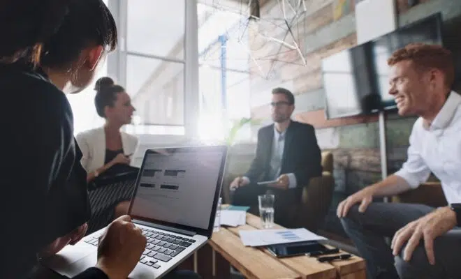 Businesswoman working on laptop in meeting