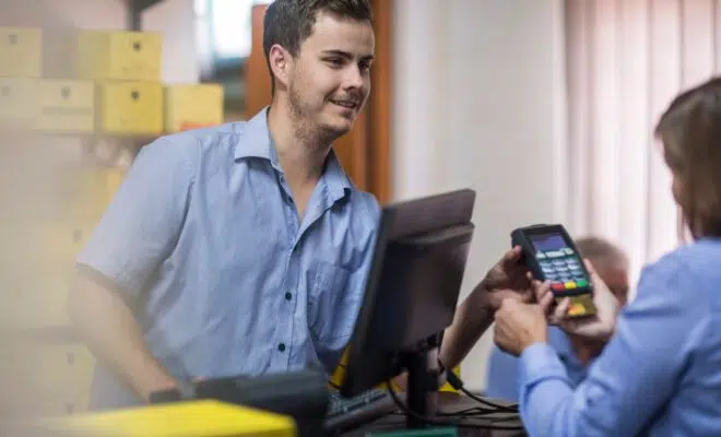 Customer using credit card reader at store