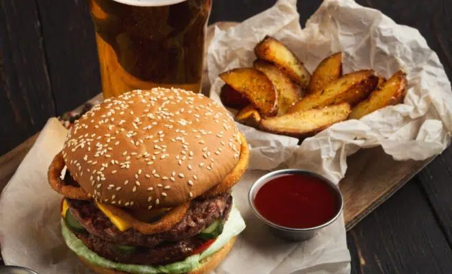 Fast food restaurant dish. Hamburger and fries wedges