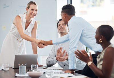 Handshake, team and agreement on business partnership meeting, merger or success on b2b collaborati