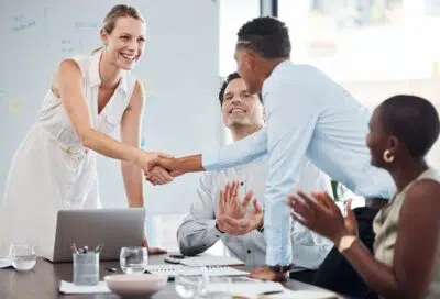 Handshake, team and agreement on business partnership meeting, merger or success on b2b collaborati