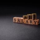 The inscription Salary made of wooden cubes on a plain background