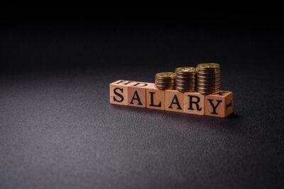 The inscription Salary made of wooden cubes on a plain background